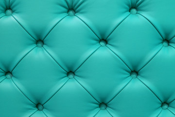Turquoise leather sofa stitched buttons. - obrazy, fototapety, plakaty