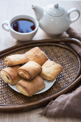 Tea with cookies on wooden tray background
