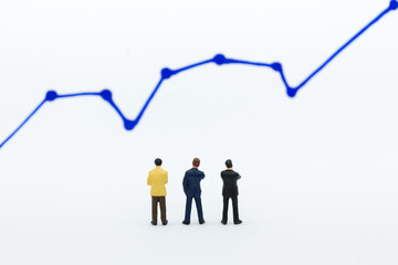 Miniature people: Businessman stand front of dashboard, display graphs, profit margins of ...