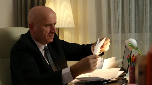 Desperate Businessman Read Accounting Documents Gesturing Nervous and Irritated