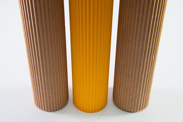 Corrugated paper rolls on the white desk.