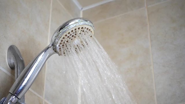 Running water shower fauset. Water stream.