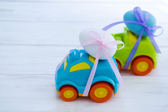 Two Easter cars tied up with colored ribbons go on the table