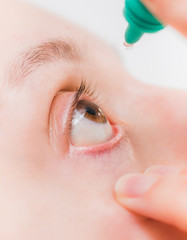 close up shot of a white female instilling eye drops