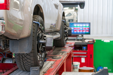Closed up of an auto wheel : computer wheel alignment.
Balancing tire wheel machine. Tyre assembling. Tyre balancing of modern car in workshop.