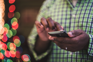 close up of african american man using mobile device