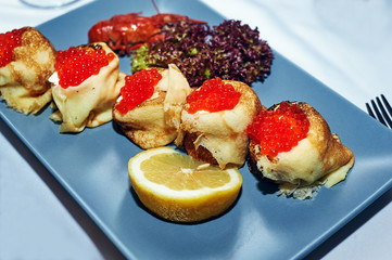 Pancakes with red caviar . Traditional Russian snack