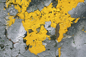 Strong surface structure with rest of yellow paint on concrete wall for abstract backgrounds.