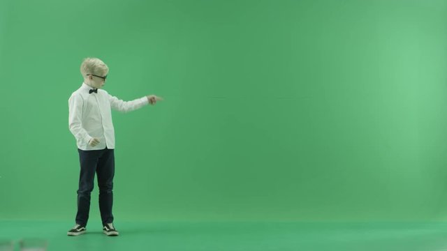 Little boy showing the forecast of hot and rainy weather on the left side on the green screen