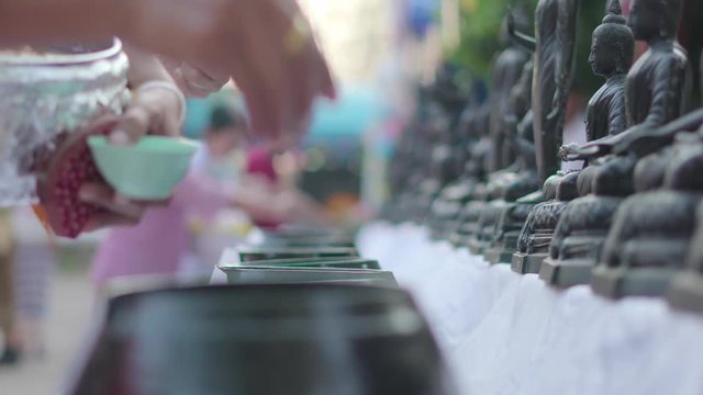 Asian people making merit by donate coins for Buddhist temple
