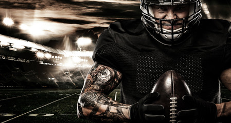 Fototapeta na wymiar American football sportsman player on stadium. Sports banner and wallpaper with copyspace.