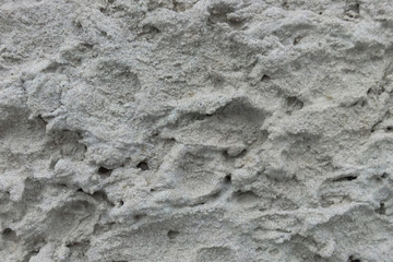 Texture of a porous concrete gray wall on the facade