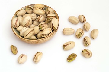 pistachio nuts on white background in a bowl