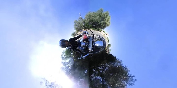 Biker on a classic motorcycle in tiny planet effect. 360 degrees video