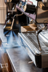 Cleaning milk frother of coffee machine with water steam jet