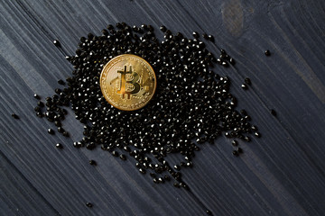 Golden bitcoin on a black jewels. Gold coin of cryptocurrency.