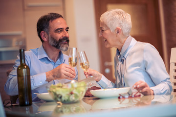 Mature couple having lunch at home