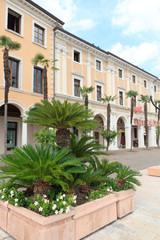 Fototapeta na wymiar Townhall and palm trees in Salo at Lake Garda, Italy
