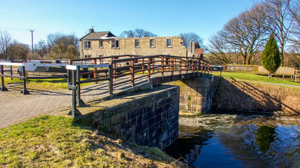 A derelict building beside a lock and bridge over the Forth and Clyde canal near the village of...