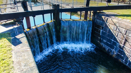  Water flowing over a lock gate on  the Forth and Clyde canal near the village of Allandale in Central Scotland.