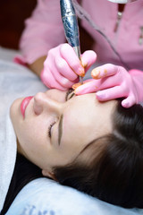 Obraz na płótnie Canvas doctor does cosmetic procedures on girl's face