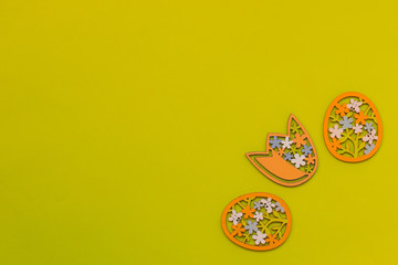 Easter eggs and flower on a yellow background