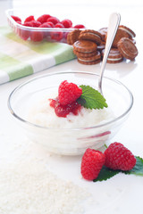 Milk Rice porridge with raspberry, white background light key