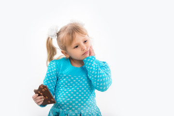 Cheerful little girl eating chocolate, isolated on white background