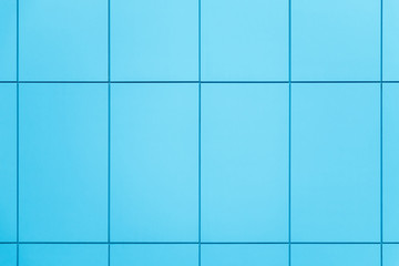 Wall coated with blue facing panels. Abstract architectural background.
