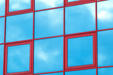 Reflection of the sky and clouds on the glass wall of the building