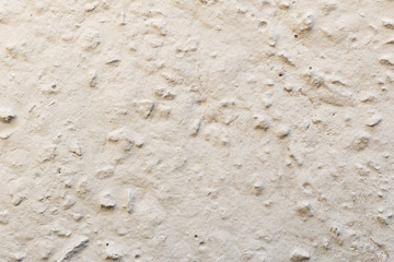 Closeup of a wall made of crushed stone plastered with cement