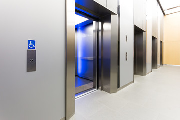 disabled signage, Modern steel elevator opened cabins in a business lobby or Hotel, Store,...