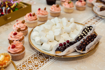 candy bar decorated by delicious sweet buffet with cupcakes and other desserts/candies,happy birthday concept