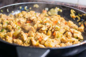 Cooking burrito in a pan with chicken, pepper, tomato for fajitas typical .Latin America food
