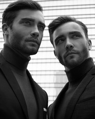 two serious businessman models thinking and look away in black and white