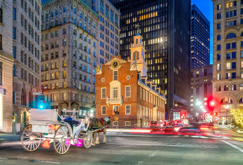 Old State House and moving blurr carriage at twilight in Boston