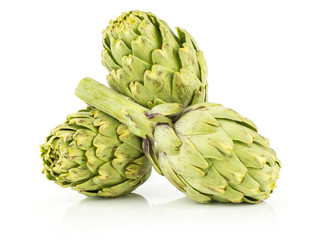Obraz premium Three globe artichoke stack isolated on white background fresh raw green.