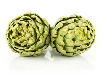 Fototapeta premium Fresh globe artichoke flowers isolated on white background raw two green.