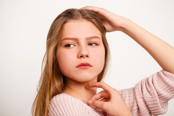 Fototapeta premium Close up portrait of a pretty young schoolgirl with dark blonde hair