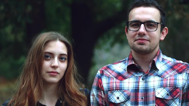 CINEMAGRAPH - seamless loop. Happy young couple hipster, look at the camera and at each other during a summer walk in the park. 4k