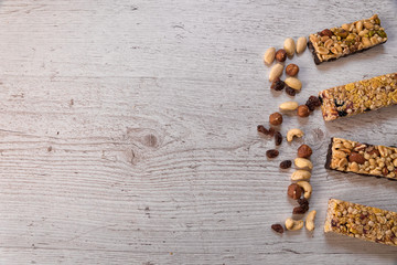 cereal sticks, healthy diet for lifestyle, ingredients - more nuts, dried plums, honey, oat flakes laid on the table