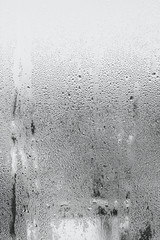 Blue background of natural water condensation, window glass with high air strong humidity, large...
