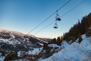 Valley view of Meribel ski resort (1450 m.) with chairlift ski lift at early morning, Three Valleys, France - obrazy, fototapety, plakaty