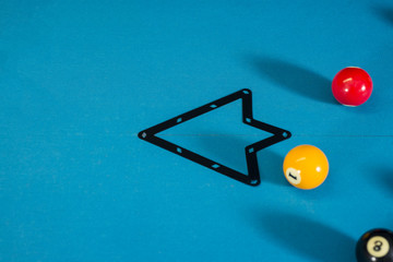 One ball on  the pool table with a rack, ready for a game of 9 ball.