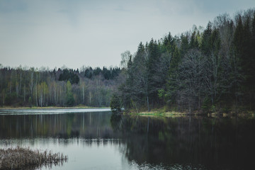 View of the lake and the forest on a cloudy day