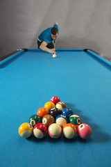 Fototapeta premium A billiard player ready to break a set of 8 ball on a professional billiard table.