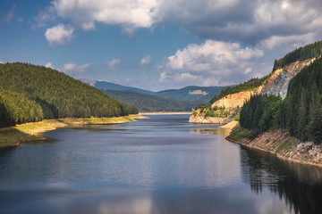 Fototapeta na wymiar Landscape with lake Oasa in Romanian Carpathians, Transalpina.