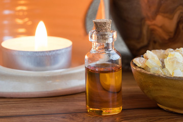 Obraz na płótnie Canvas A bottle of frankincense essential oil with frankincense resin