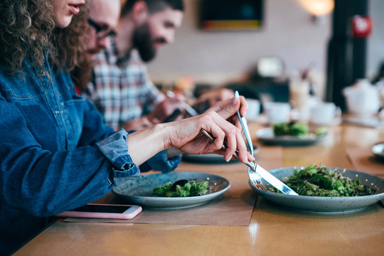 Woman Eat Salad  In Restaurant With Friends.