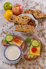 healthy breakfast, cereal sticks in mycelium with nuts, two pans of vegetables laid on the table
